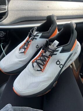 On Running Cloud Shoes in White with Orange and Black Accents